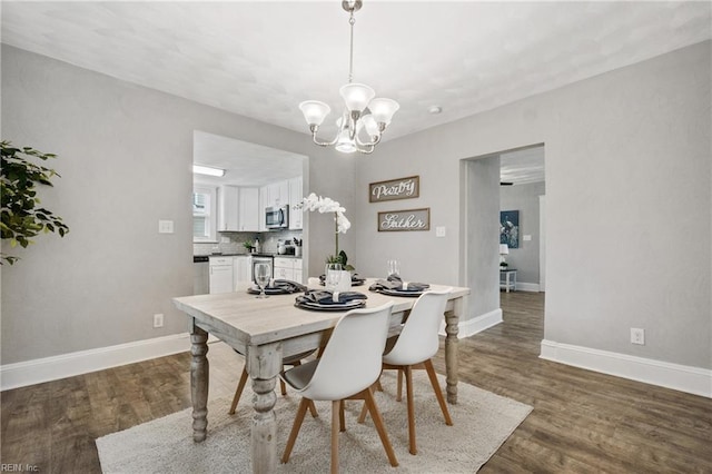 dining room featuring a notable chandelier and dark hardwood / wood-style floors