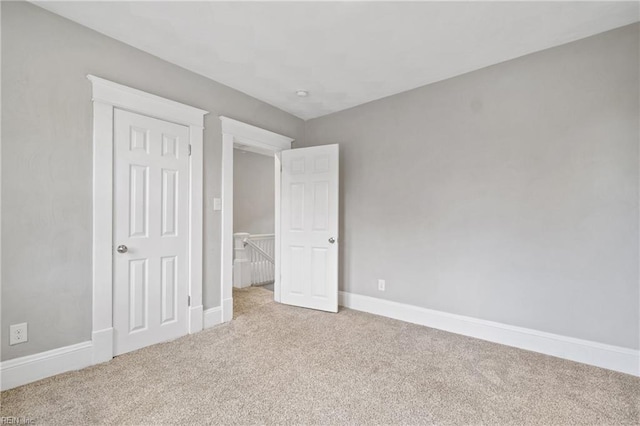 unfurnished bedroom with light colored carpet