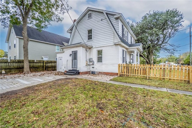 rear view of property featuring a yard