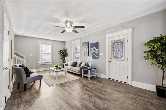 living room featuring dark hardwood / wood-style flooring and ceiling fan