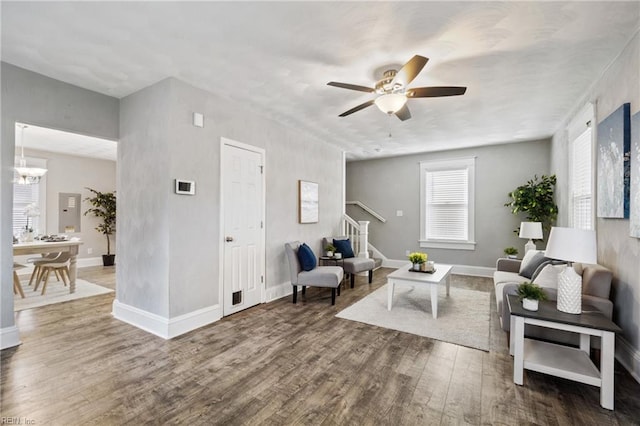 living room featuring wood-type flooring and ceiling fan