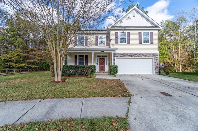 view of front of property with a garage and a front lawn