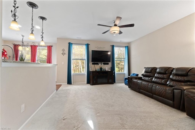 carpeted living room with plenty of natural light and ceiling fan