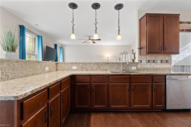 kitchen featuring dishwasher, dark wood-type flooring, sink, light stone countertops, and kitchen peninsula