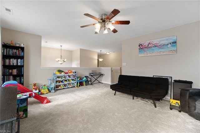 playroom with carpet flooring and ceiling fan with notable chandelier