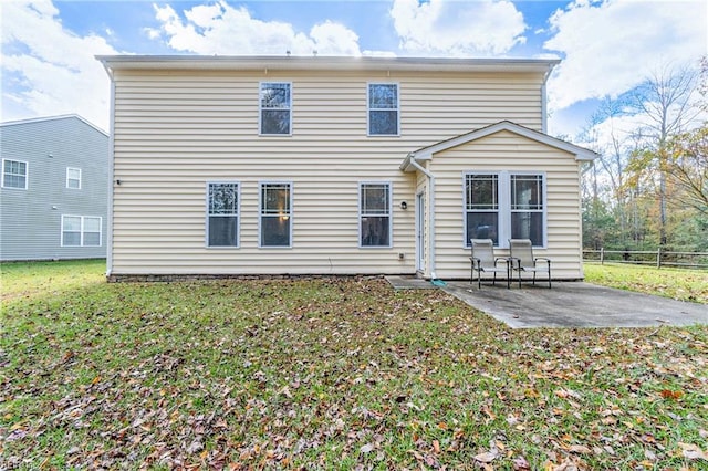 rear view of house featuring a yard and a patio