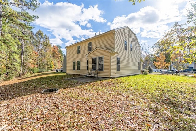 back of property featuring a patio area and a yard