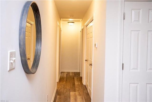 hallway with dark hardwood / wood-style floors