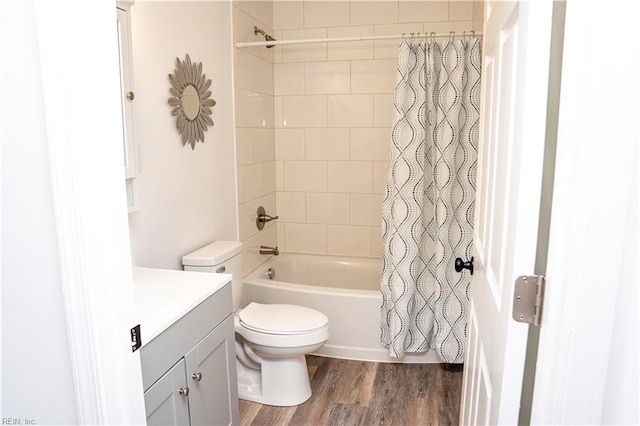 full bathroom featuring toilet, shower / bath combo with shower curtain, vanity, and hardwood / wood-style flooring