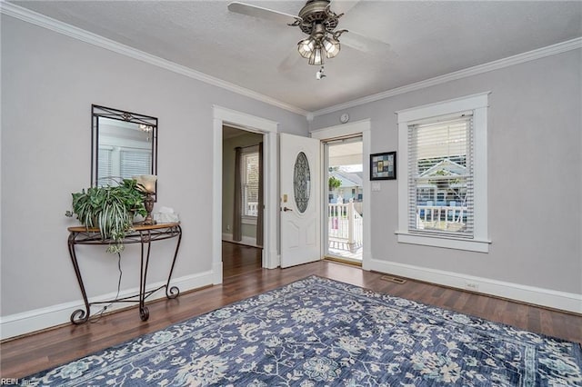 foyer featuring a textured ceiling, ceiling fan, crown molding, and dark hardwood / wood-style floors