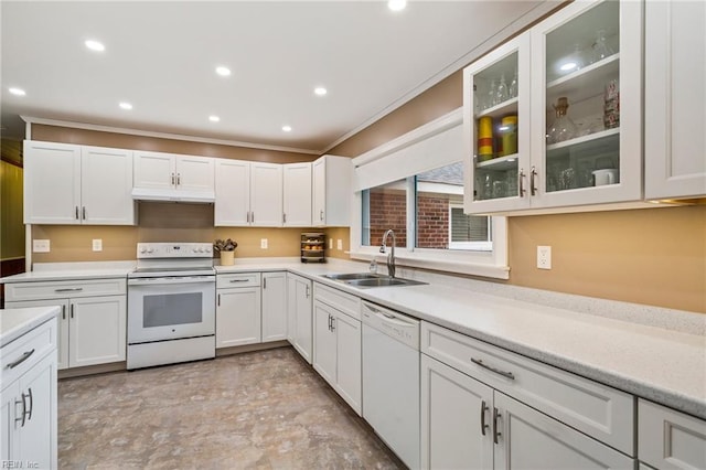 kitchen with white cabinetry, sink, crown molding, and white appliances