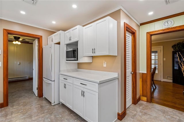 kitchen featuring ornamental molding, baseboard heating, white refrigerator, white cabinetry, and stainless steel microwave