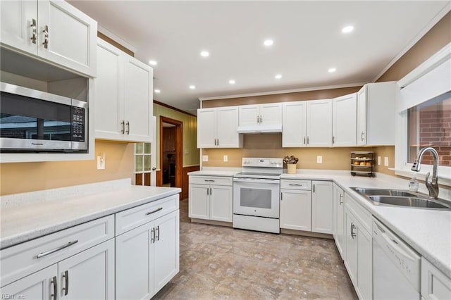 kitchen featuring crown molding, sink, white cabinets, and white appliances