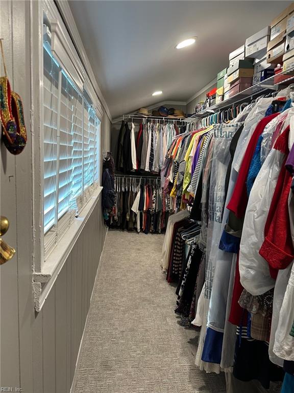 spacious closet featuring lofted ceiling and carpet floors