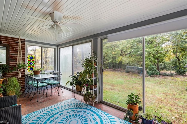 sunroom / solarium featuring ceiling fan