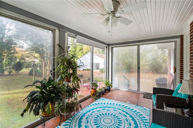 sunroom featuring ceiling fan and wooden ceiling