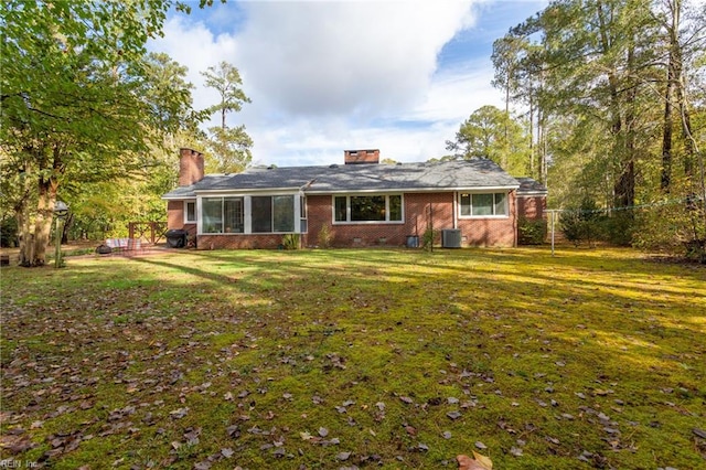 view of front of house featuring a front yard and central AC