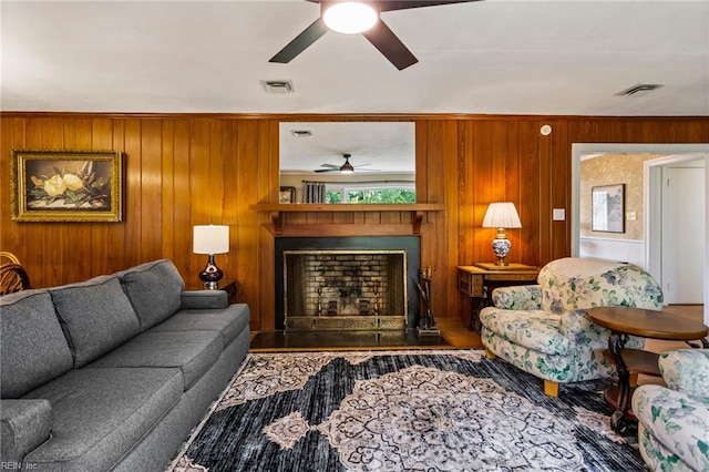 living room featuring hardwood / wood-style floors, ceiling fan, and wood walls