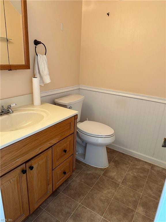 bathroom with tile patterned floors, vanity, and toilet