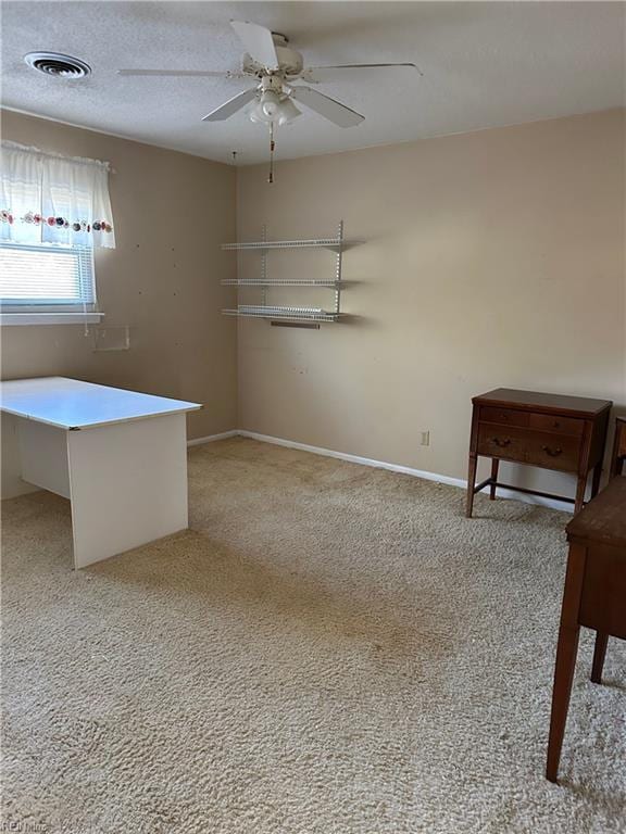 interior space featuring ceiling fan and light colored carpet