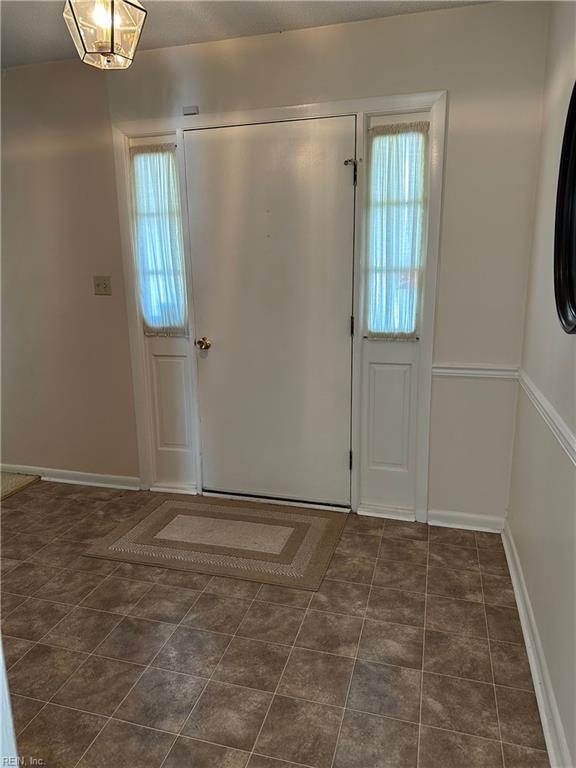 tiled entryway with a healthy amount of sunlight