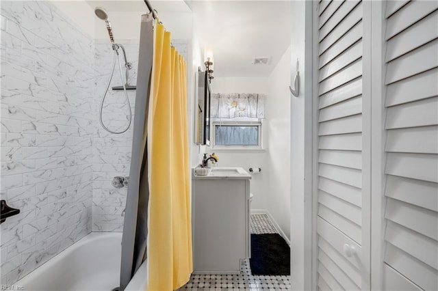 bathroom featuring tile patterned flooring, shower / tub combo, and vanity