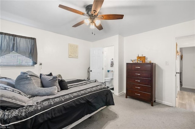 carpeted bedroom featuring connected bathroom and ceiling fan