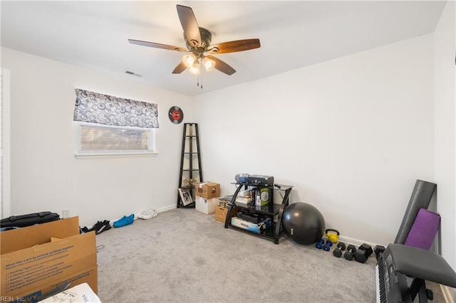 exercise area featuring light carpet and ceiling fan