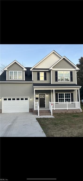 view of front of property with a porch and a garage