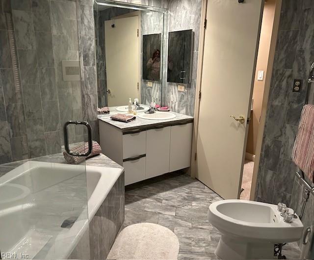 bathroom featuring a bidet, vanity, and shower with separate bathtub