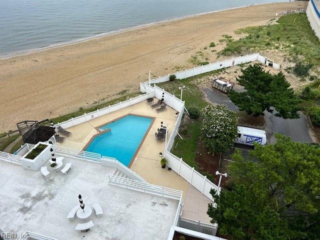 drone / aerial view featuring a water view and a view of the beach