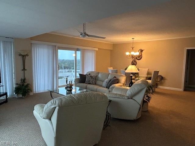 living room featuring carpet floors, ceiling fan with notable chandelier, and ornamental molding