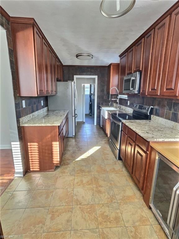 kitchen featuring backsplash, light stone countertops, and stainless steel appliances