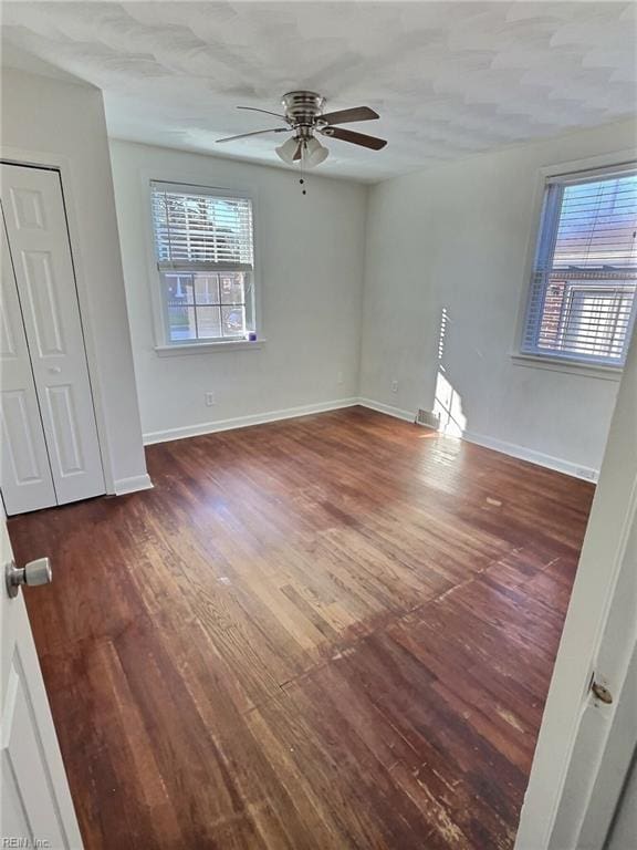 interior space with ceiling fan, dark hardwood / wood-style flooring, and a healthy amount of sunlight