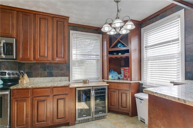 kitchen featuring ornamental molding, stainless steel appliances, decorative light fixtures, a chandelier, and wine cooler