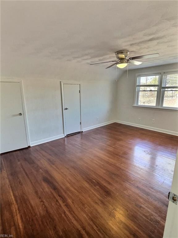 empty room featuring ceiling fan and dark wood-type flooring