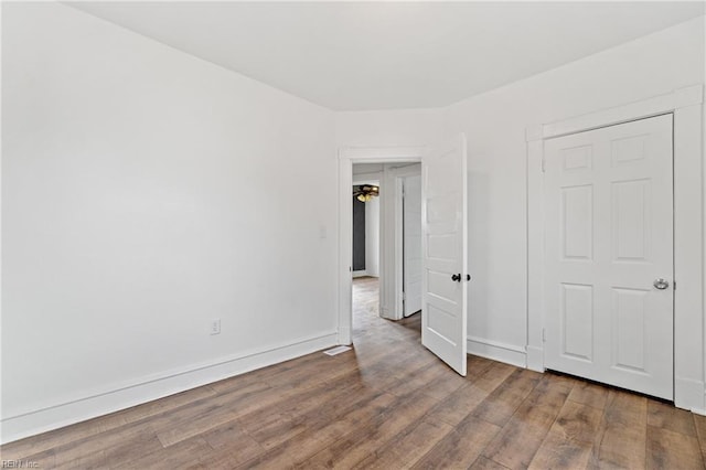 unfurnished bedroom featuring hardwood / wood-style flooring