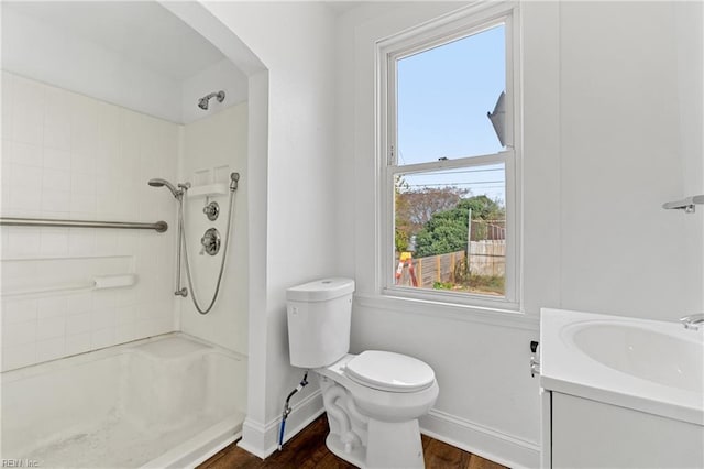 bathroom with walk in shower, vanity, and plenty of natural light