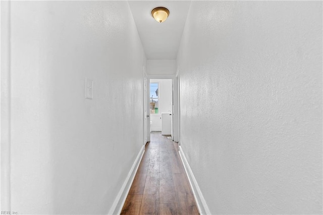 hallway with hardwood / wood-style flooring