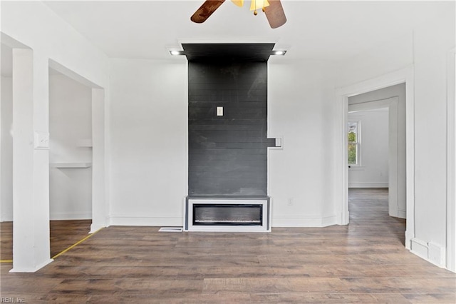 unfurnished living room featuring hardwood / wood-style flooring and ceiling fan