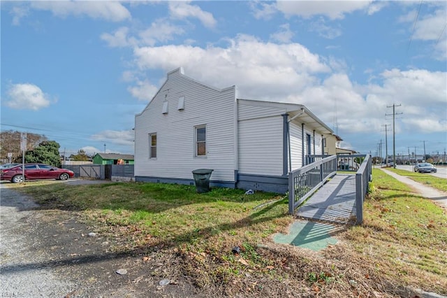 view of side of property with a yard