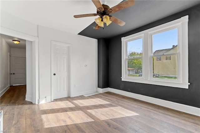 unfurnished bedroom with ceiling fan and light hardwood / wood-style flooring