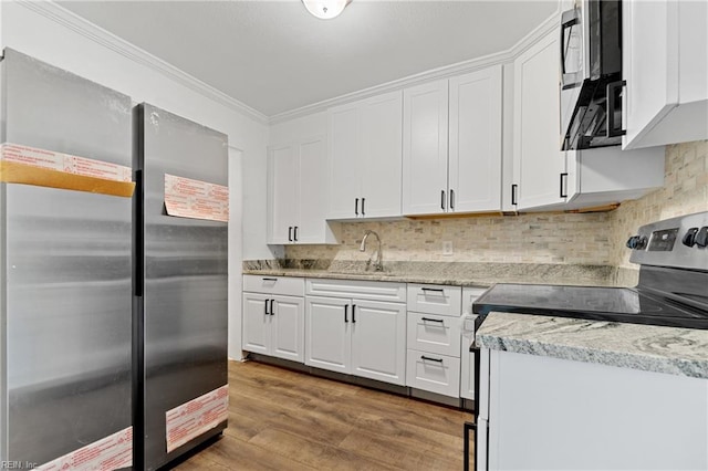 kitchen with white cabinetry, sink, light wood-type flooring, and appliances with stainless steel finishes