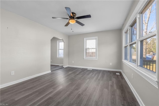 unfurnished room with ceiling fan and dark hardwood / wood-style flooring