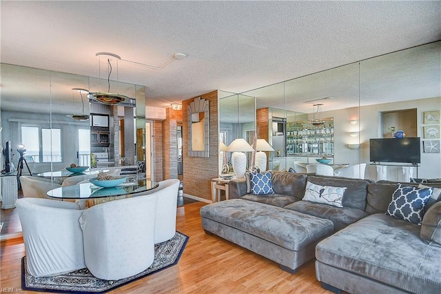 living room featuring light hardwood / wood-style floors and a textured ceiling