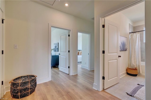 hall with light hardwood / wood-style floors