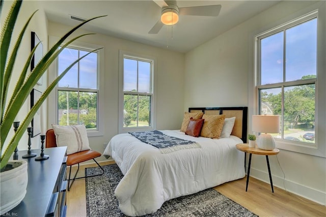 bedroom with ceiling fan and light wood-type flooring