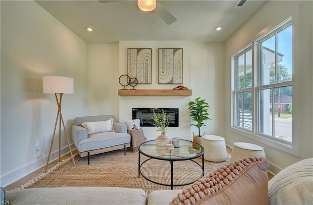 living room with a wealth of natural light, ceiling fan, and wood-type flooring