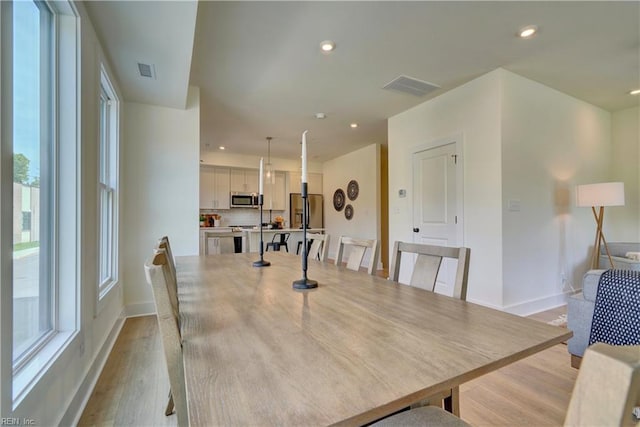 dining space featuring light hardwood / wood-style flooring