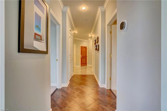 hall with tile patterned flooring and crown molding